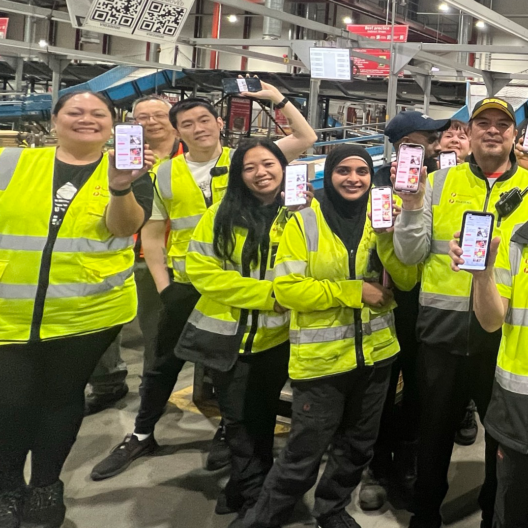 SPF team mebers showing off their Isac Hub on their phones