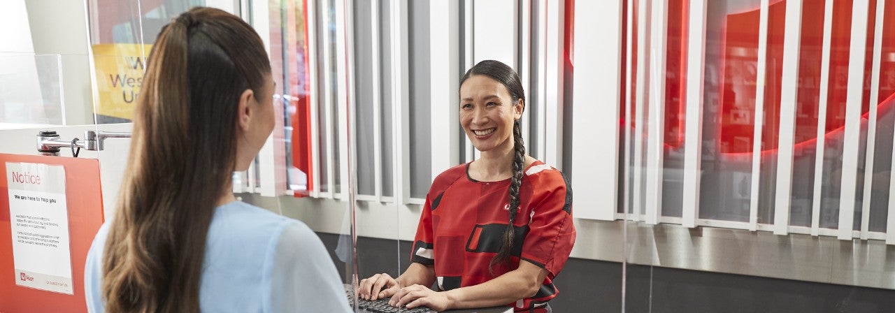 photo-woman-serving-woman-at-post-office-counter