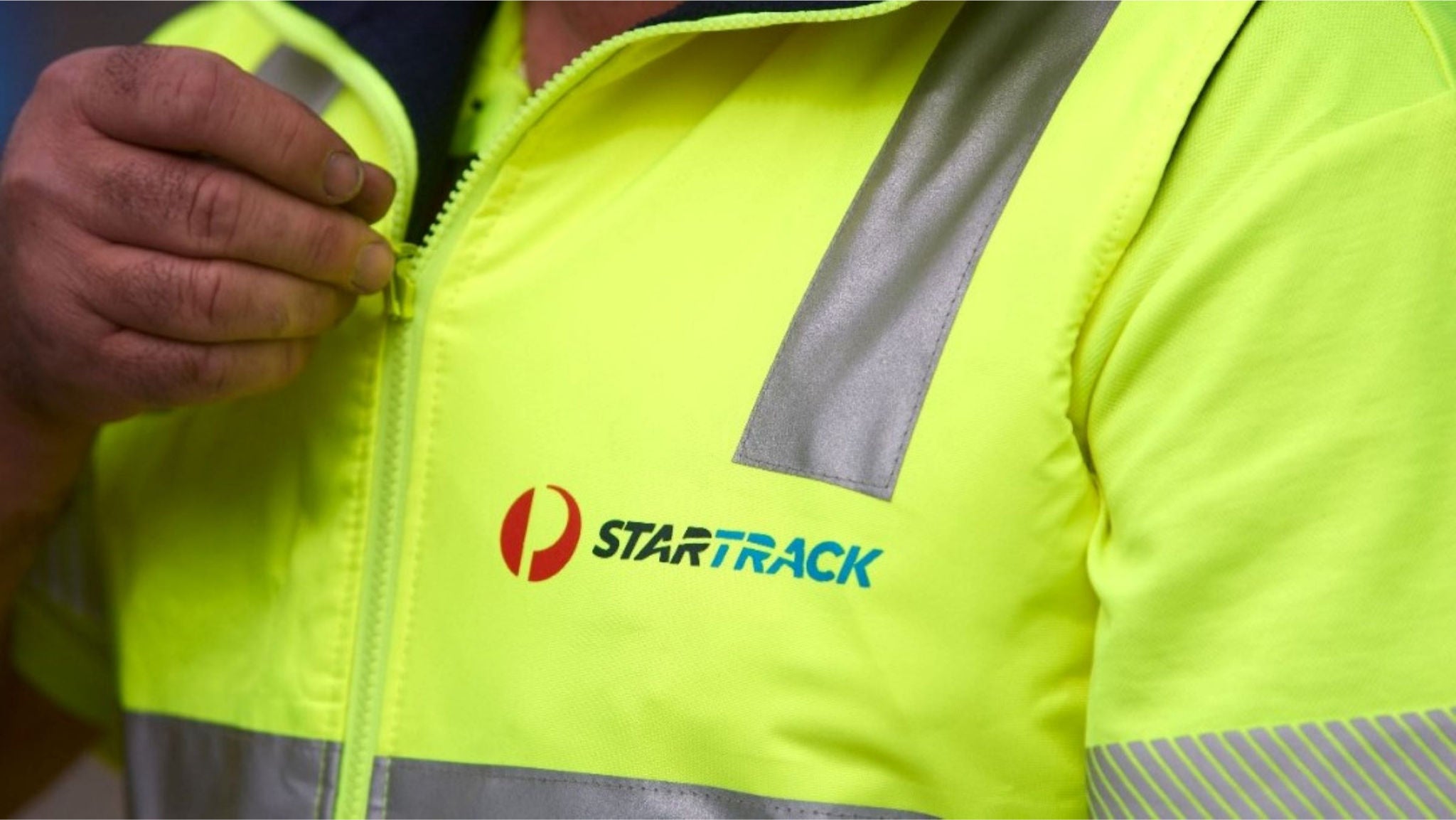 Close up of a Startrack driver yellow safety shirt
