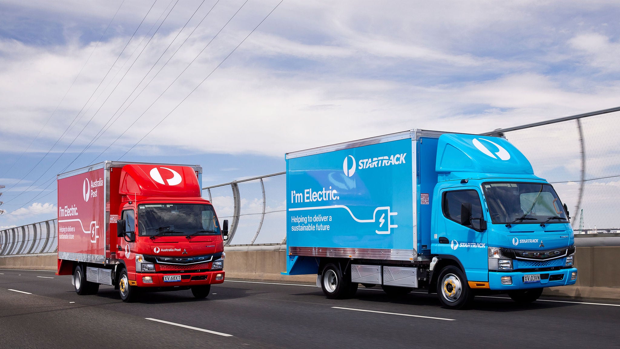 photo-australia-post-and-startrack-truck-on-the-road-together-electric