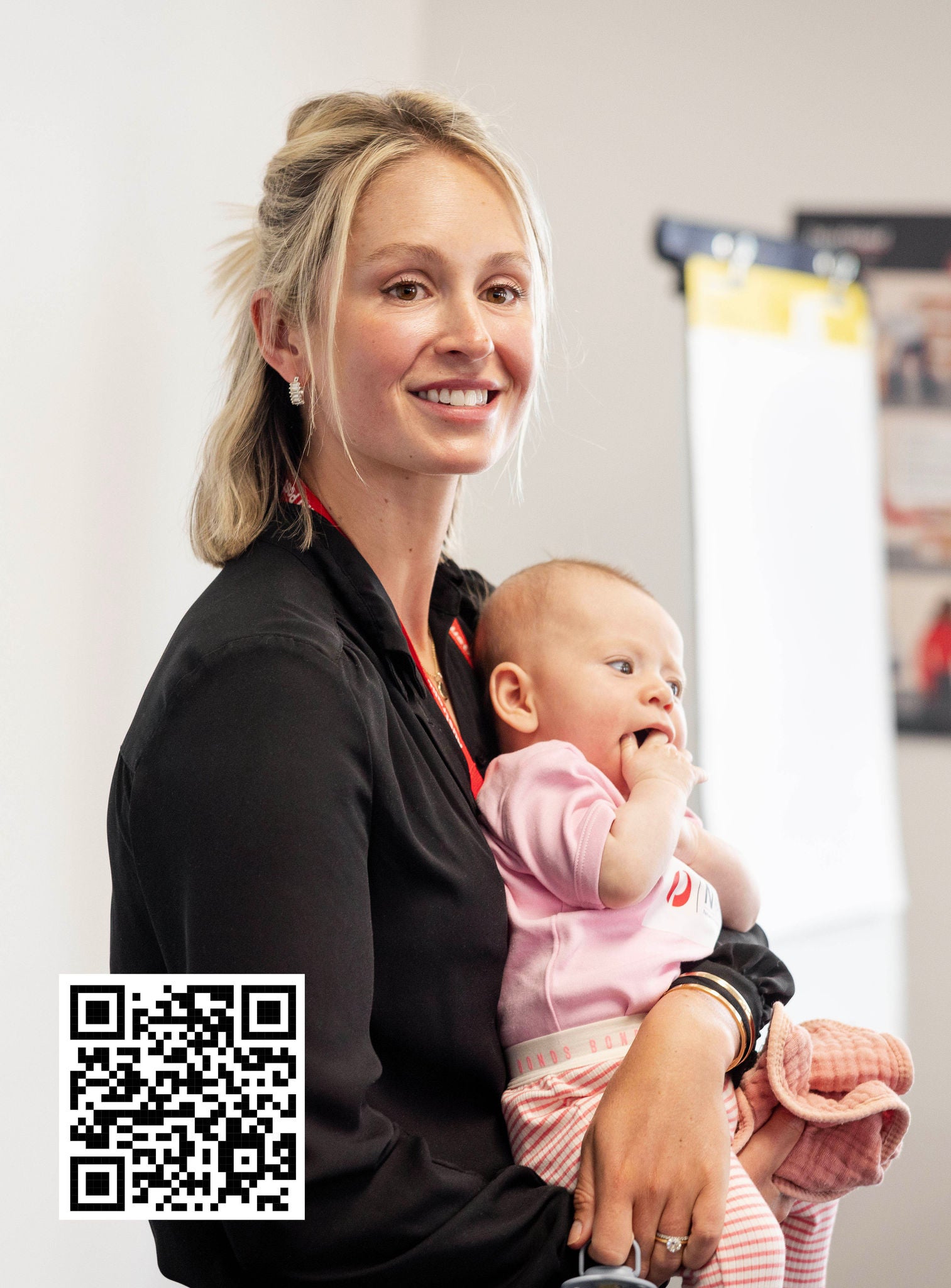 Woman holding a baby in a home setting