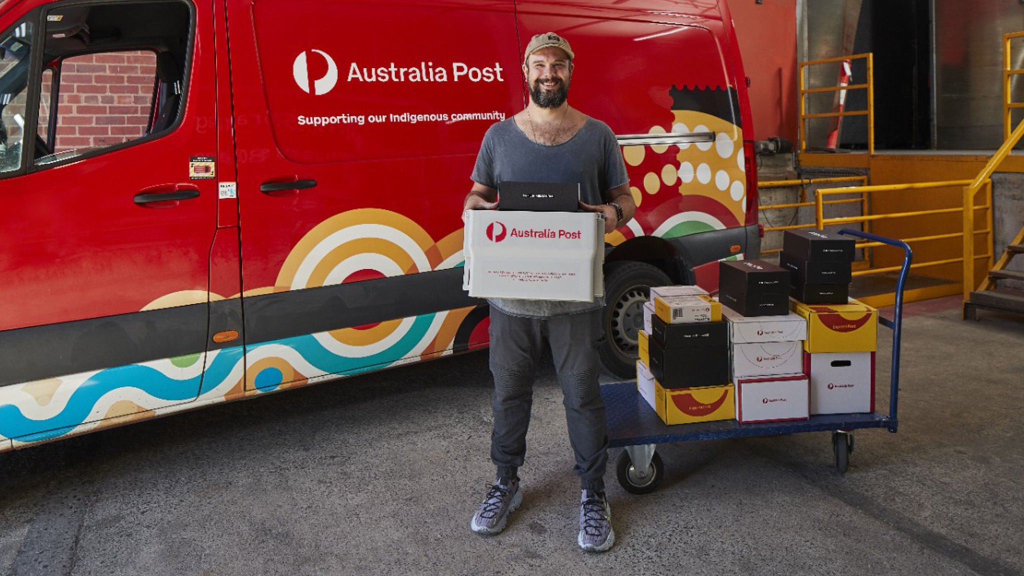 photo-man-post-van-inidgenous-parcels-trolley