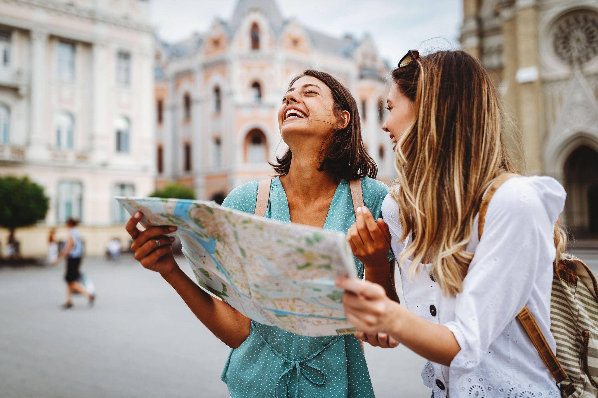 Two female tourists holding a map