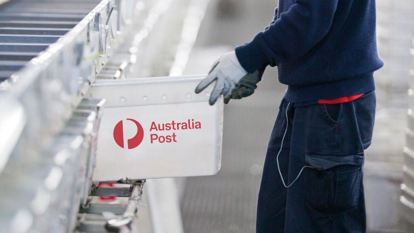 Letter centre male staff checking postal tub