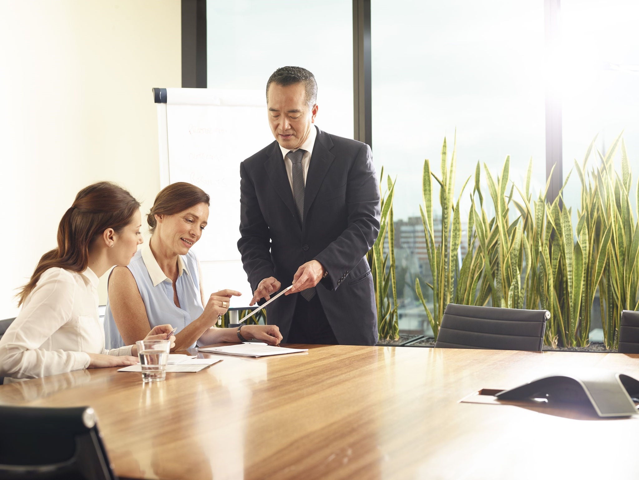 Photo of three people sitting in meeting room