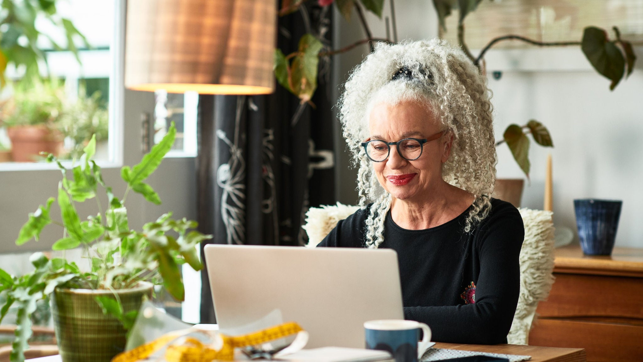 A woman using laptop in home office