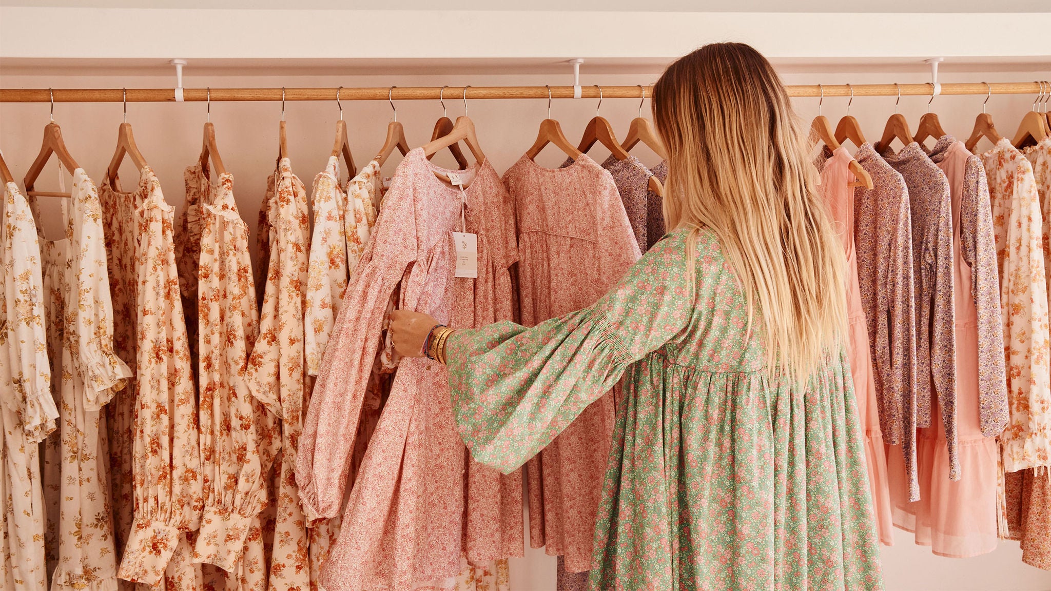photo-woman-browsing-rack-of-dresses-in-oak-meadow-boutique