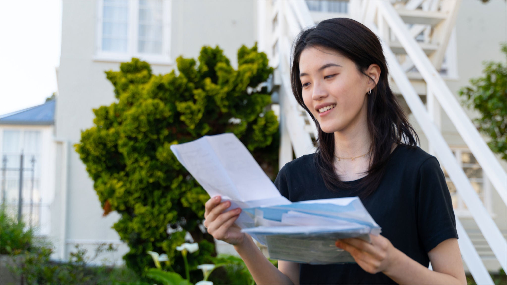 photo-lady-reading-mail-letters-outside-house-steps