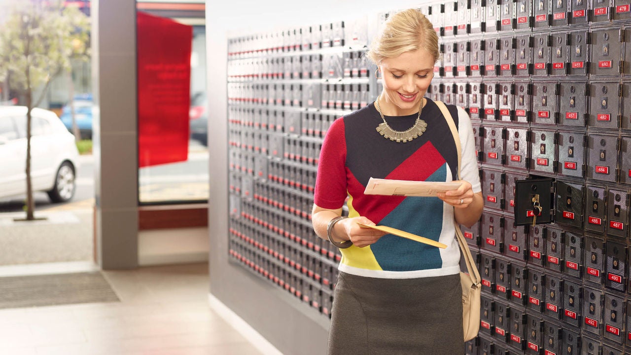 A woman looking at a letter